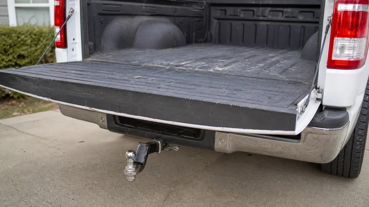 Ford F-150 open tailgate, bed liner, and trailer hitch detail